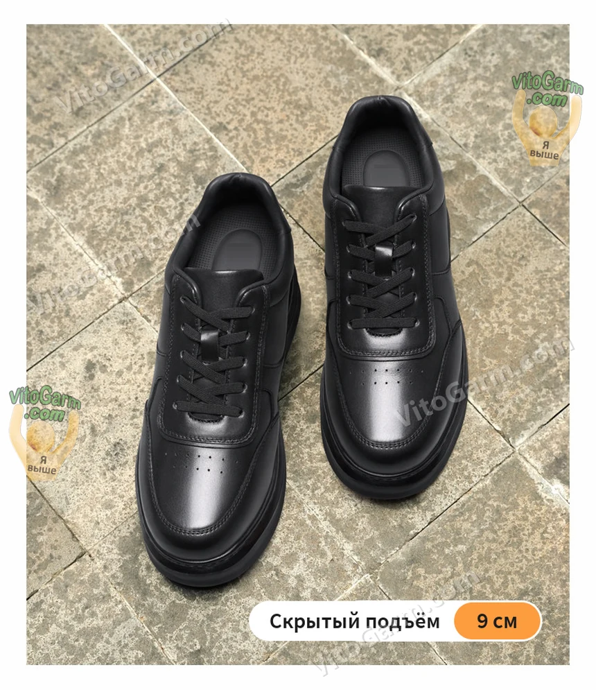 Пара чёрных кожаных кед сверху на каменной плитке